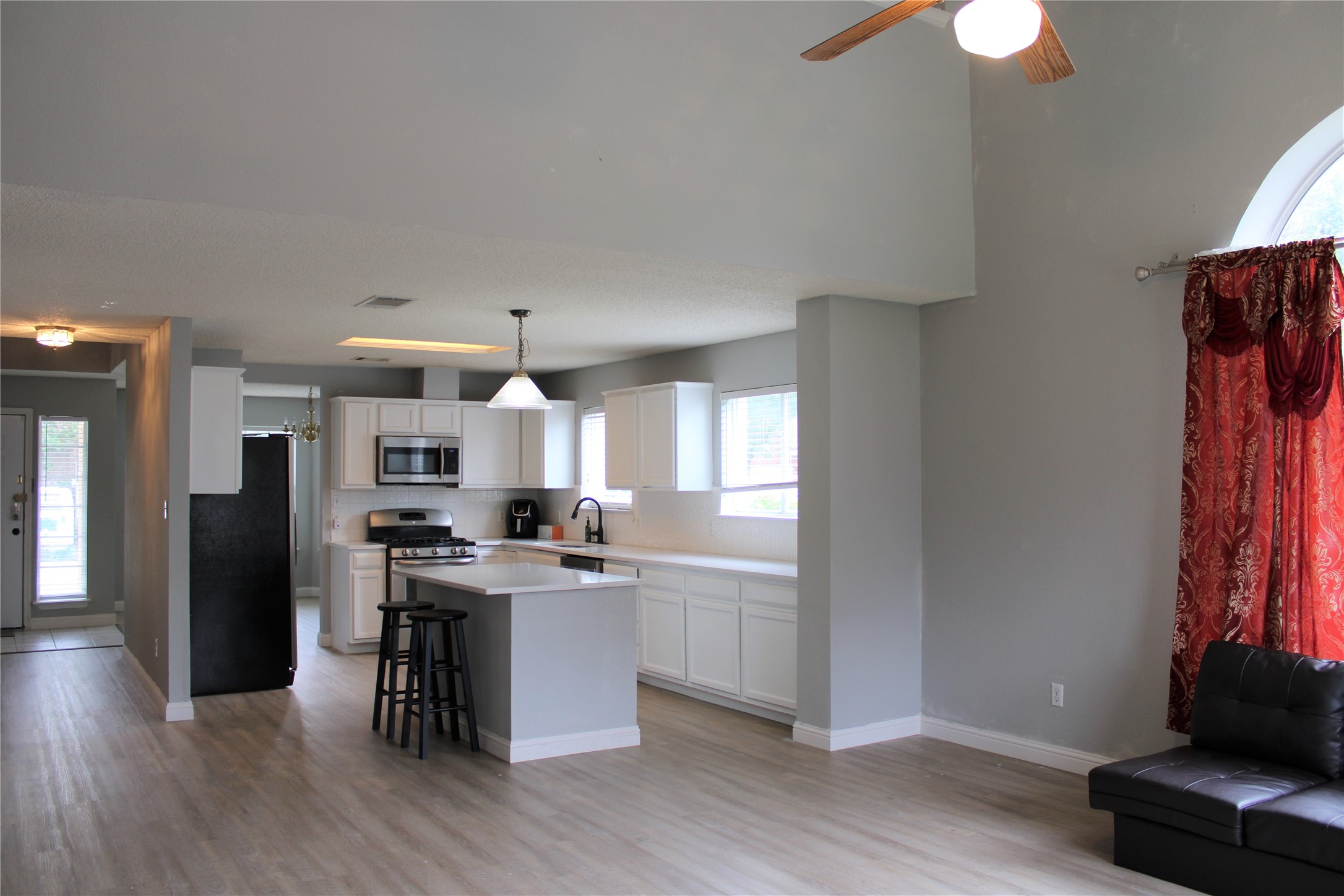 16205 Glorious Lane Pflugerville, TX 78660 - Photo 7 of 30 a kitchen with stainless steel appliances a dining table chairs and a refrigerator