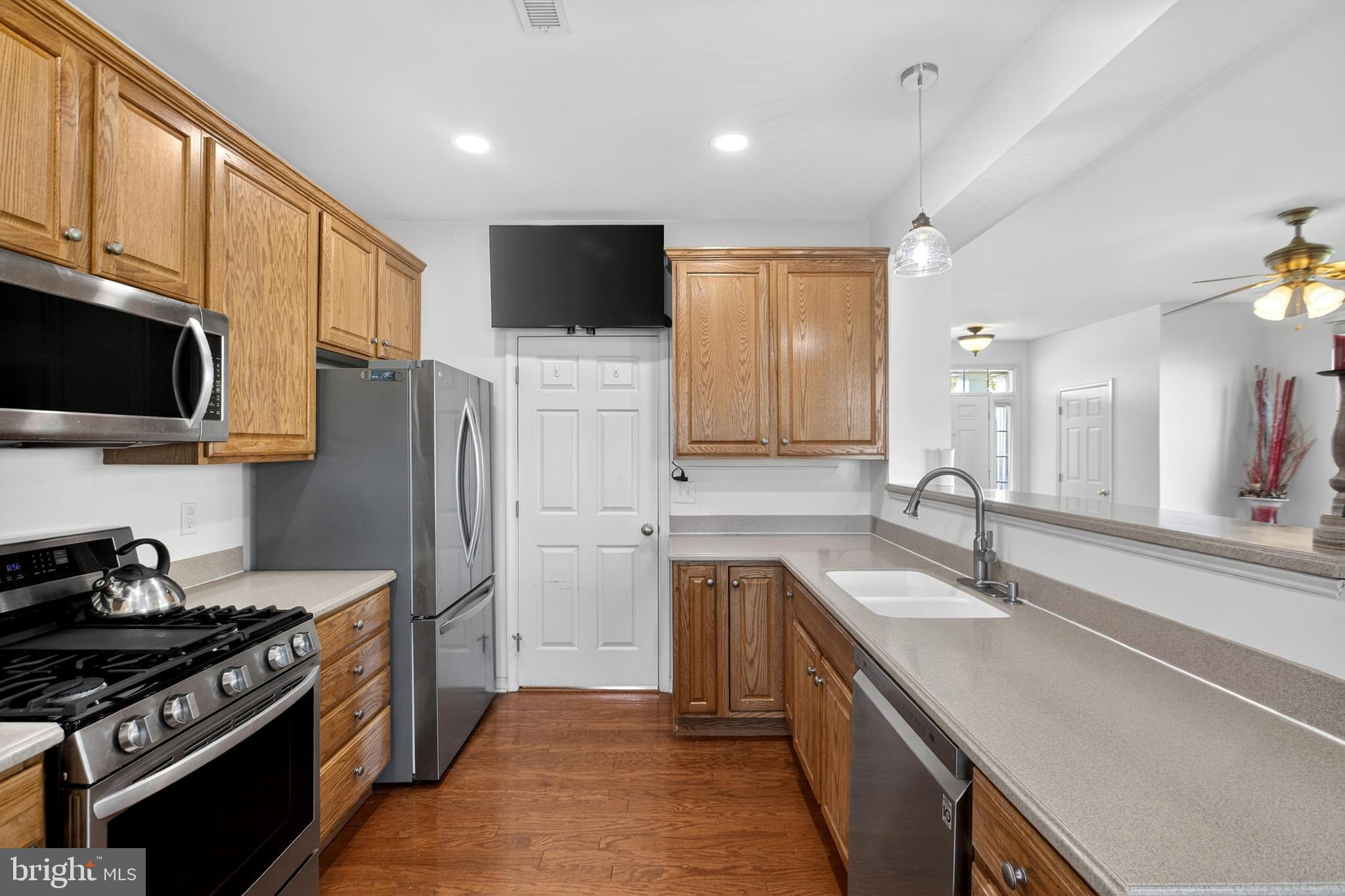24 Springfield Circle Middletown, DE 19709 - Photo 22 of 72 a kitchen with stainless steel appliances a sink a stove top oven a refrigerator cabinets and a window