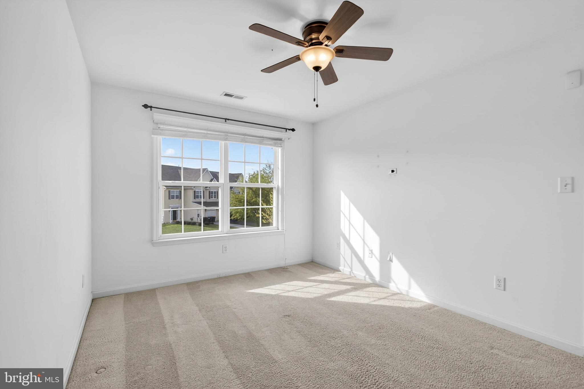 24 Springfield Circle Middletown, DE 19709 - Photo 33 of 72 an empty room with a window and a fan