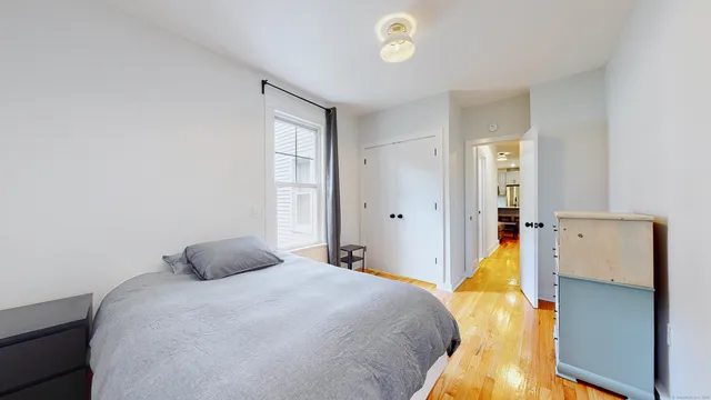 a bedroom with a bed and a window