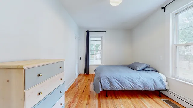 a bedroom with a bed and window