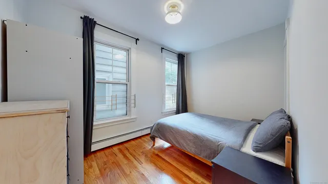 a bedroom with a bed and a window