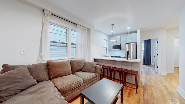 a living room with kitchen island furniture and a wooden floor