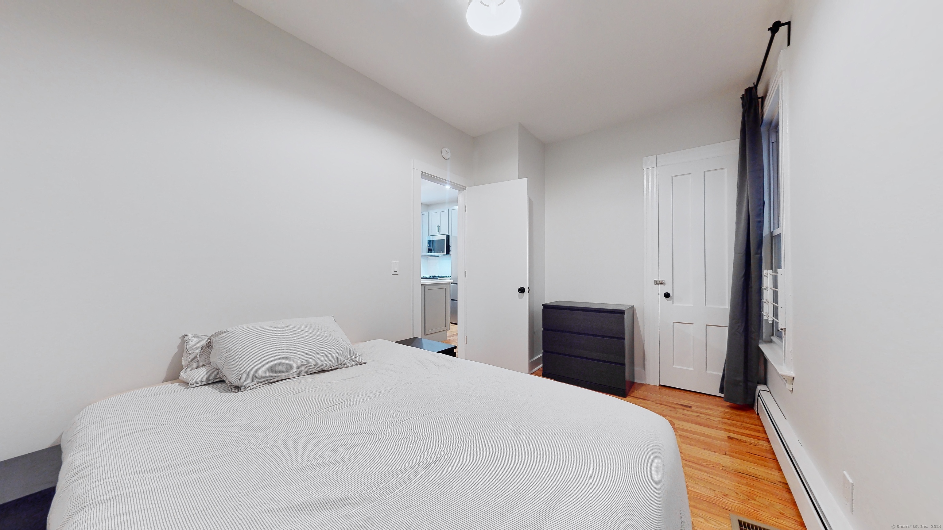 86 Edwards Street, Unit 1 New Haven, CT 06511 - Photo 25 of 40 a bedroom with a bed and wooden floor