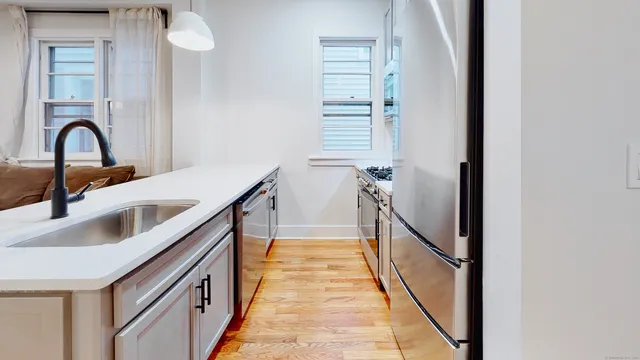 a view of a bathroom sink and a window