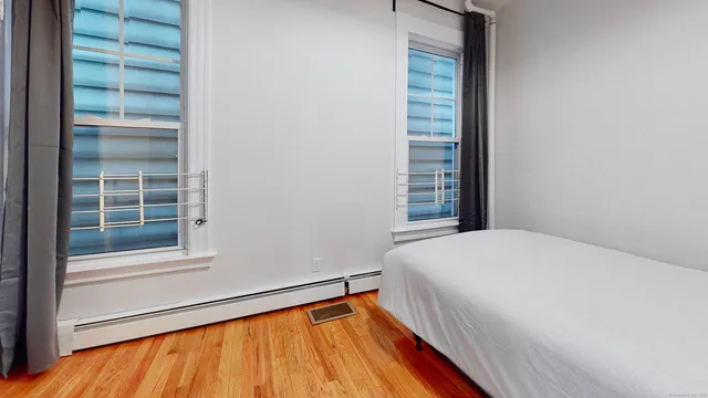 a bedroom with a bed and a window