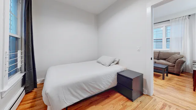 a bedroom with a bed and a couch