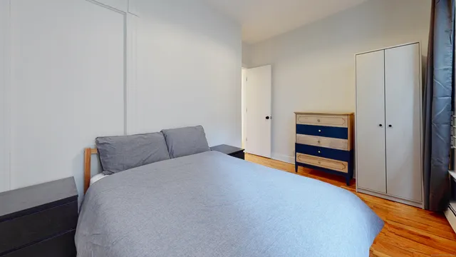 a bedroom with a bed and a cabinets