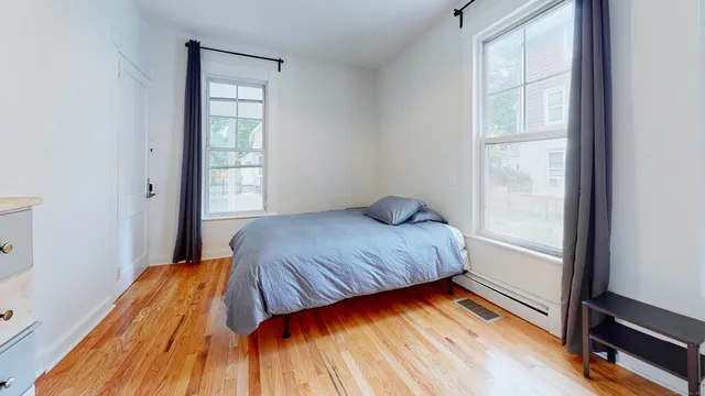 a bedroom with a bed and a window