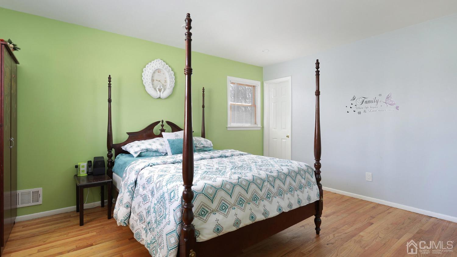 20 Peake Road Edison, NJ 08837 - Photo 15 of 34 a bed sitting in a bedroom next to a window and wooden floor