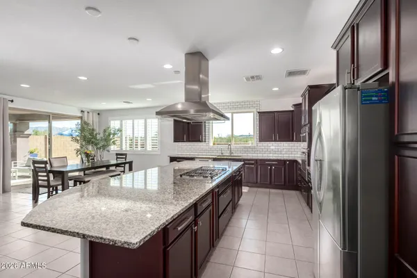 a kitchen with stainless steel appliances granite countertop a sink counter space and refrigerator