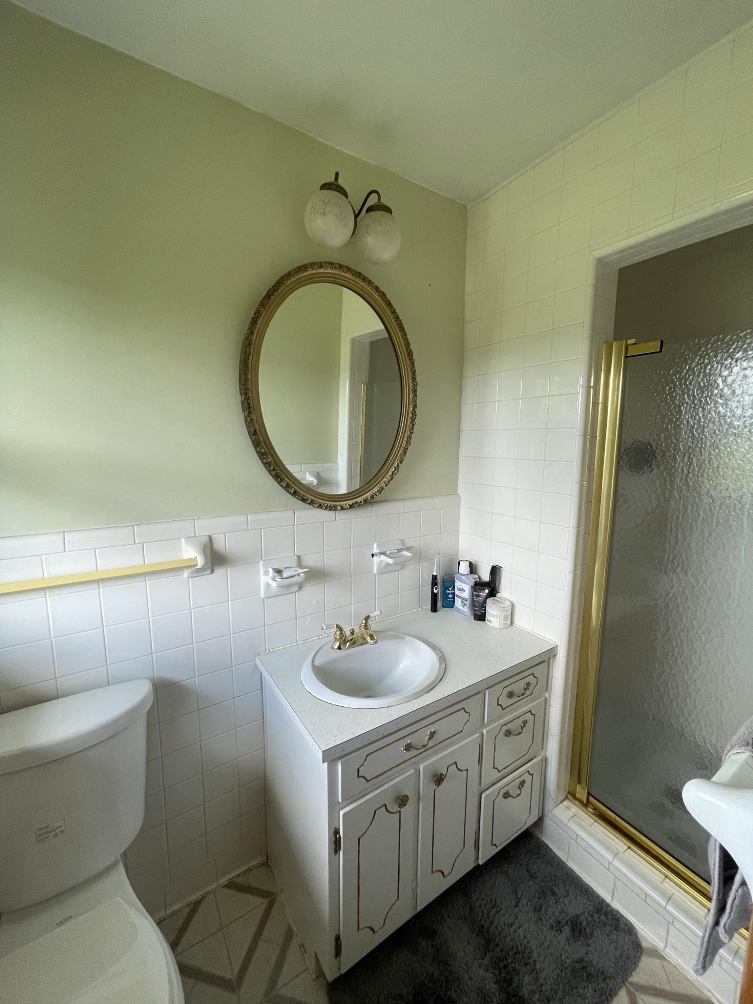 1135 Oddfellows Road Vinton, VA 24179 - Photo 13 of 34 a bathroom with a granite countertop toilet a sink and a mirror
