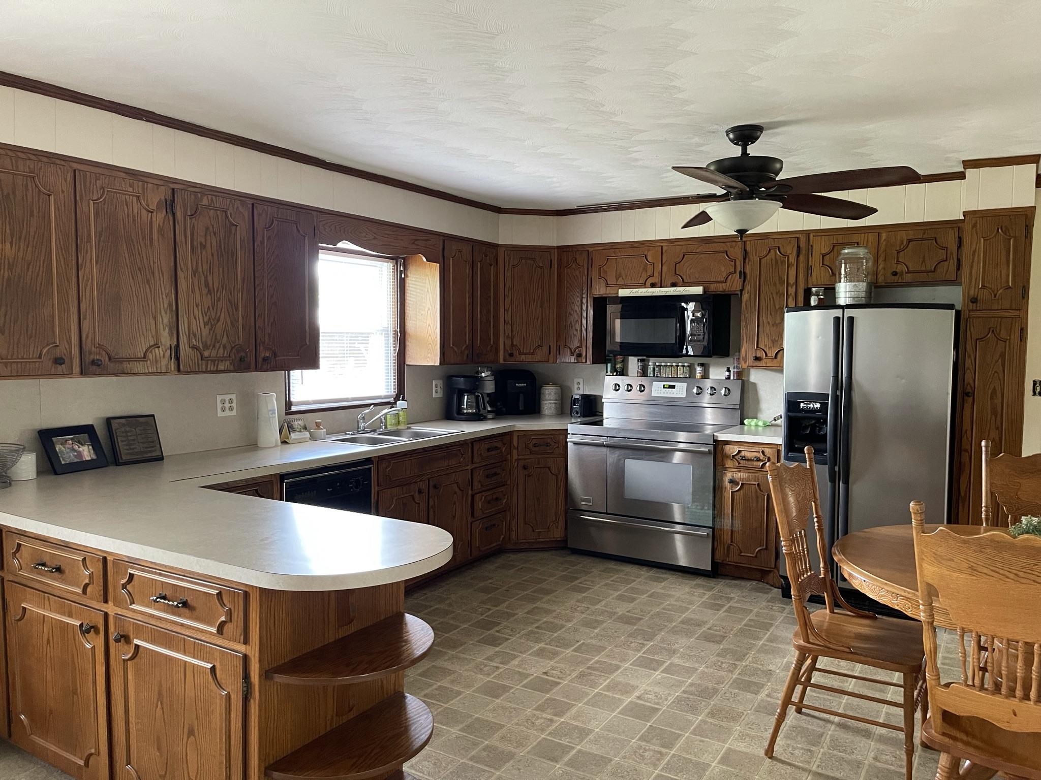 1135 Oddfellows Road Vinton, VA 24179 - Photo 5 of 34 a kitchen with cabinets a sink stainless steel appliances and window