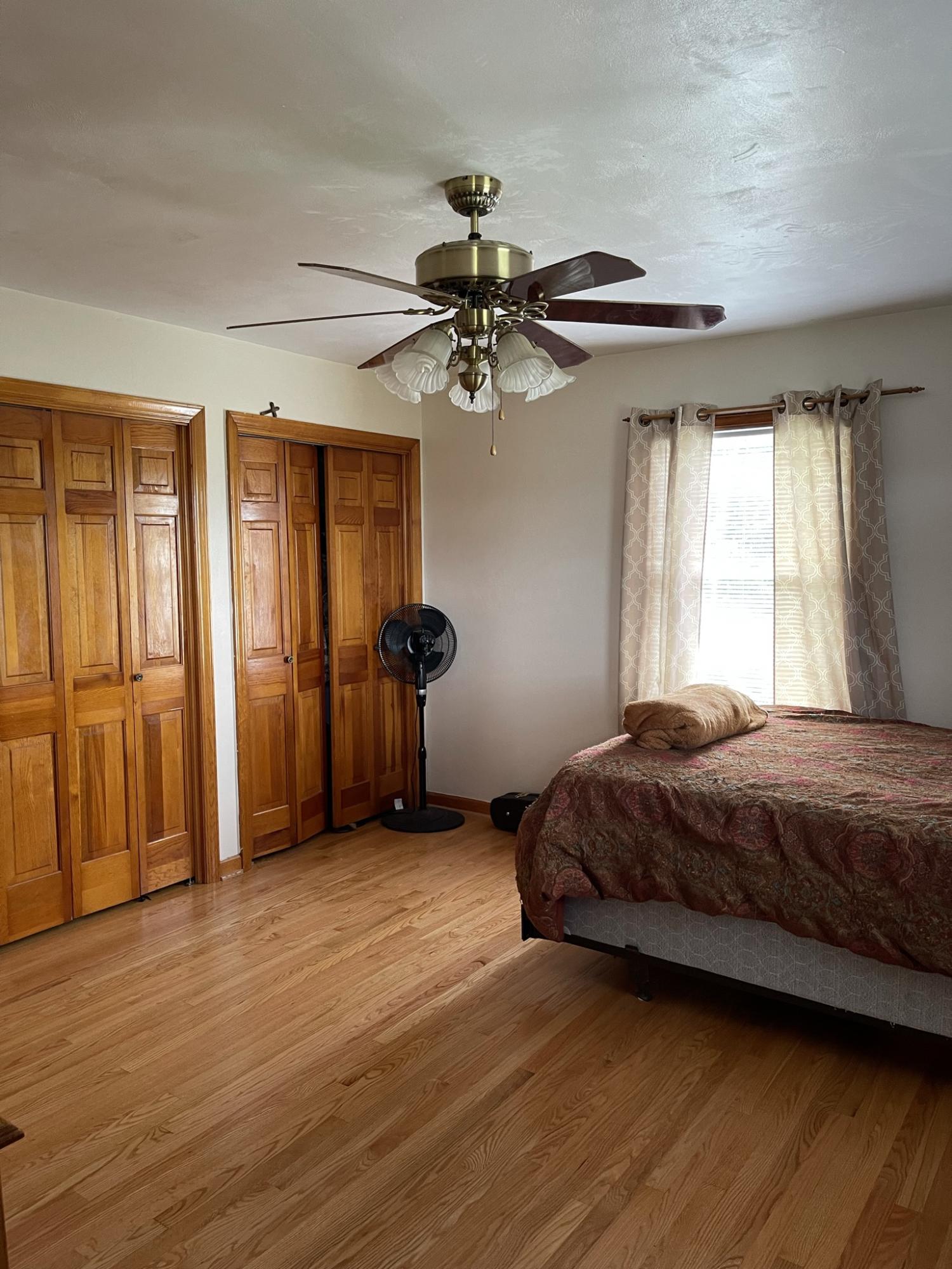 1135 Oddfellows Road Vinton, VA 24179 - Photo 10 of 34 a bedroom with a bed and a chandelier