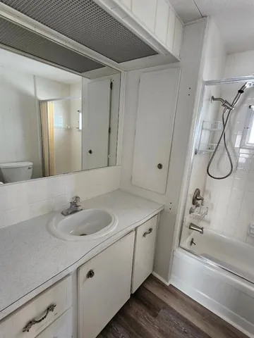 a bathroom with a granite countertop sink and a mirror