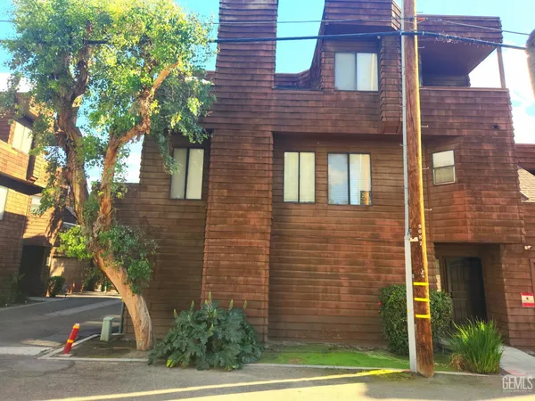 a brick building with a tree in front of it