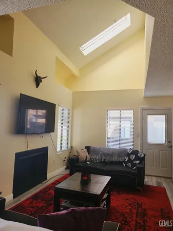 a living room with fireplace furniture and a flat screen tv