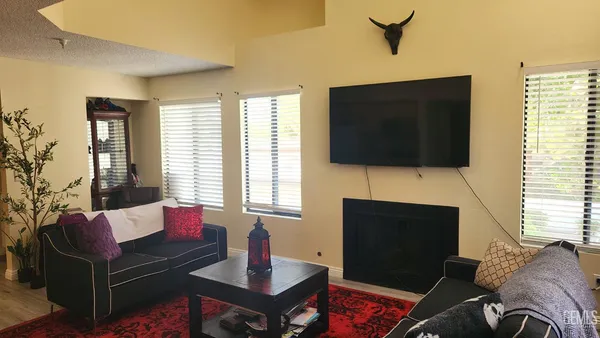 a living room with fireplace furniture and a flat screen tv