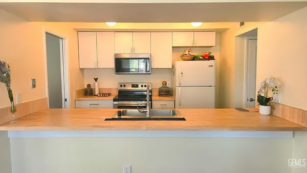 a kitchen with a refrigerator a stove and a microwave