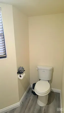 a white toilet sitting next to a shower
