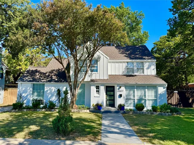 a front view of a house with a yard table and chairs