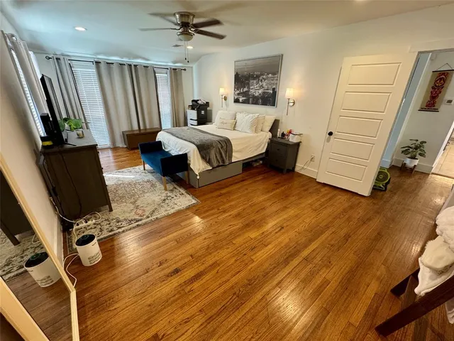 a living room with a bed furniture and a flat tv screen