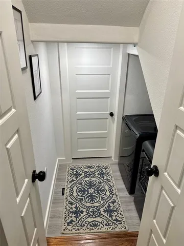 a view of walk in closet with wooden floor and stairs