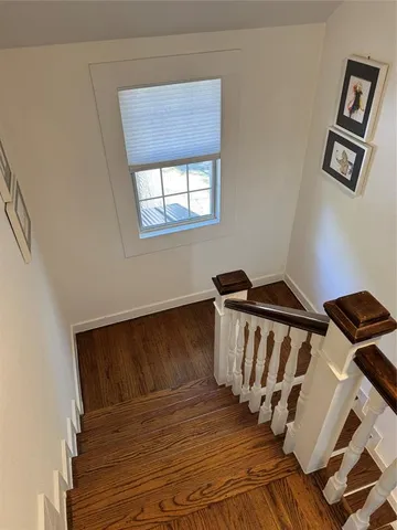 a spacious bedroom with a bed couch and a window