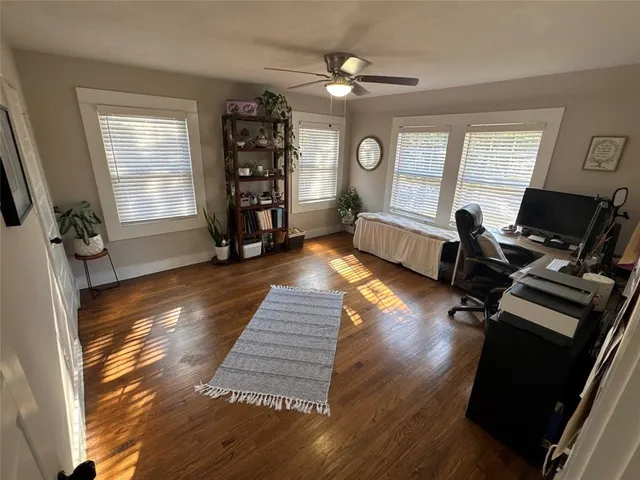 a bed sitting in a bedroom next to a window