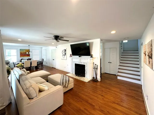 a living room with furniture a fireplace and a flat screen tv