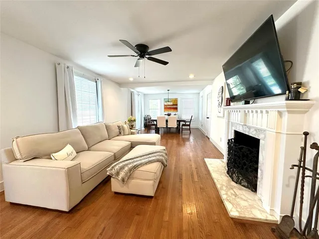 a living room with furniture fireplace and flat screen tv