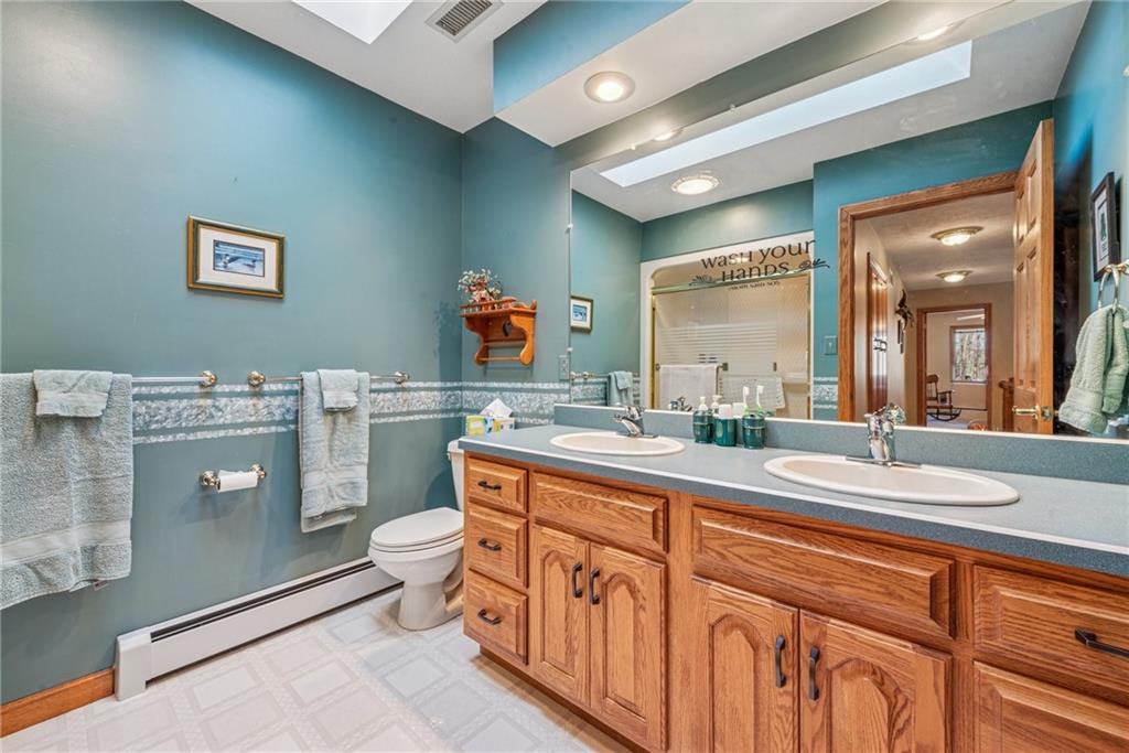 404 Oneida Trail Mercer, PA 16137 - Photo 25 of 50 Guest bathroom on the upper level, complete with double sinks, vaulted ceilings & a skylight.