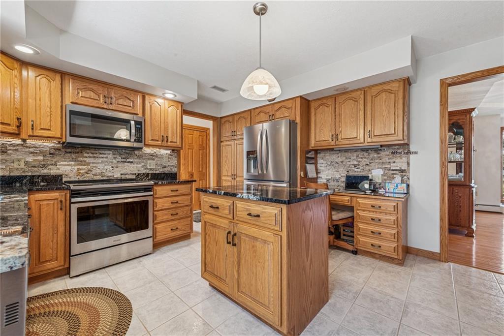 404 Oneida Trail Mercer, PA 16137 - Photo 3 of 50 Nice sized eat-in kitchen with island, plenty of storage space, wooden cabinetry, SS appliances and a stone back splash.
