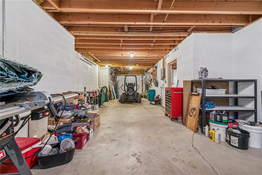 404 Oneida Trail Mercer, PA 16137 - Photo 34 of 50 Additional garage large, complete with a sink & enough space for all the lawn equipment, golf carts, tools or anything else you may need to store. Ash cleanout for first floor fireplace as well.