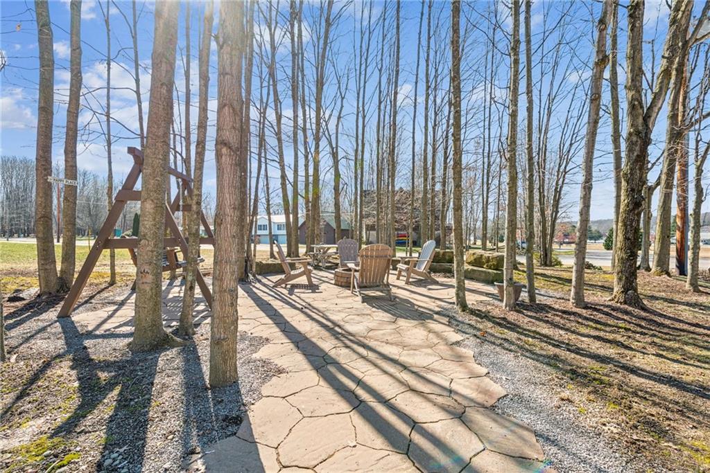 404 Oneida Trail Mercer, PA 16137 - Photo 39 of 50 Private firepit area surrounded by maple trees, complete with round stone firepit & a picnic table.
