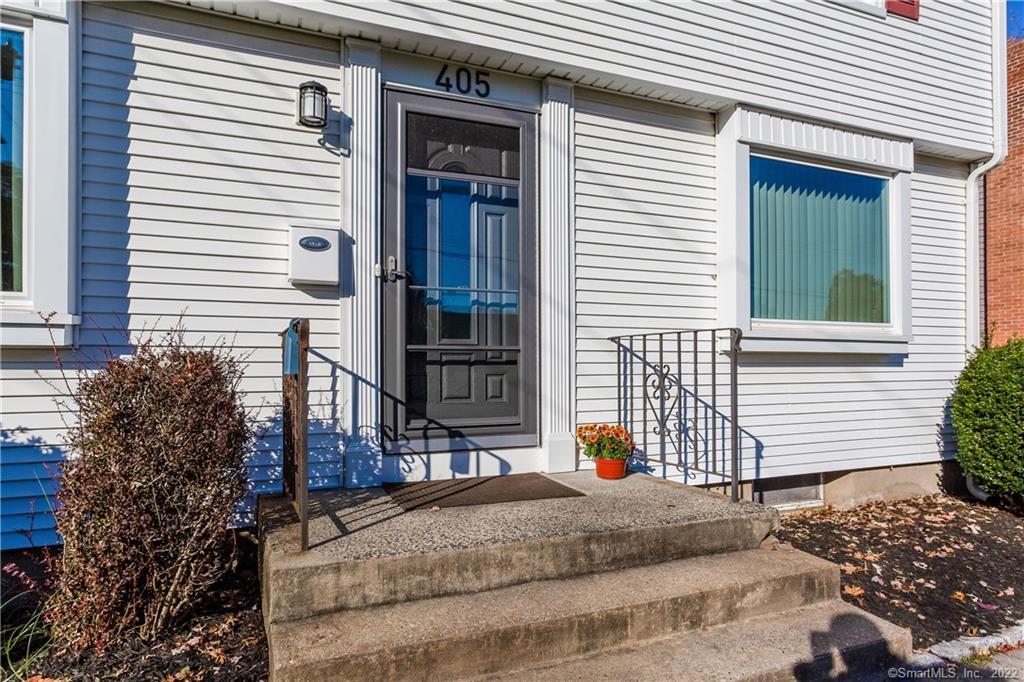 405 Brimfield Road Wethersfield, CT 06109 - Photo 1 of 1 a backyard of a house with wooden fence and large windows