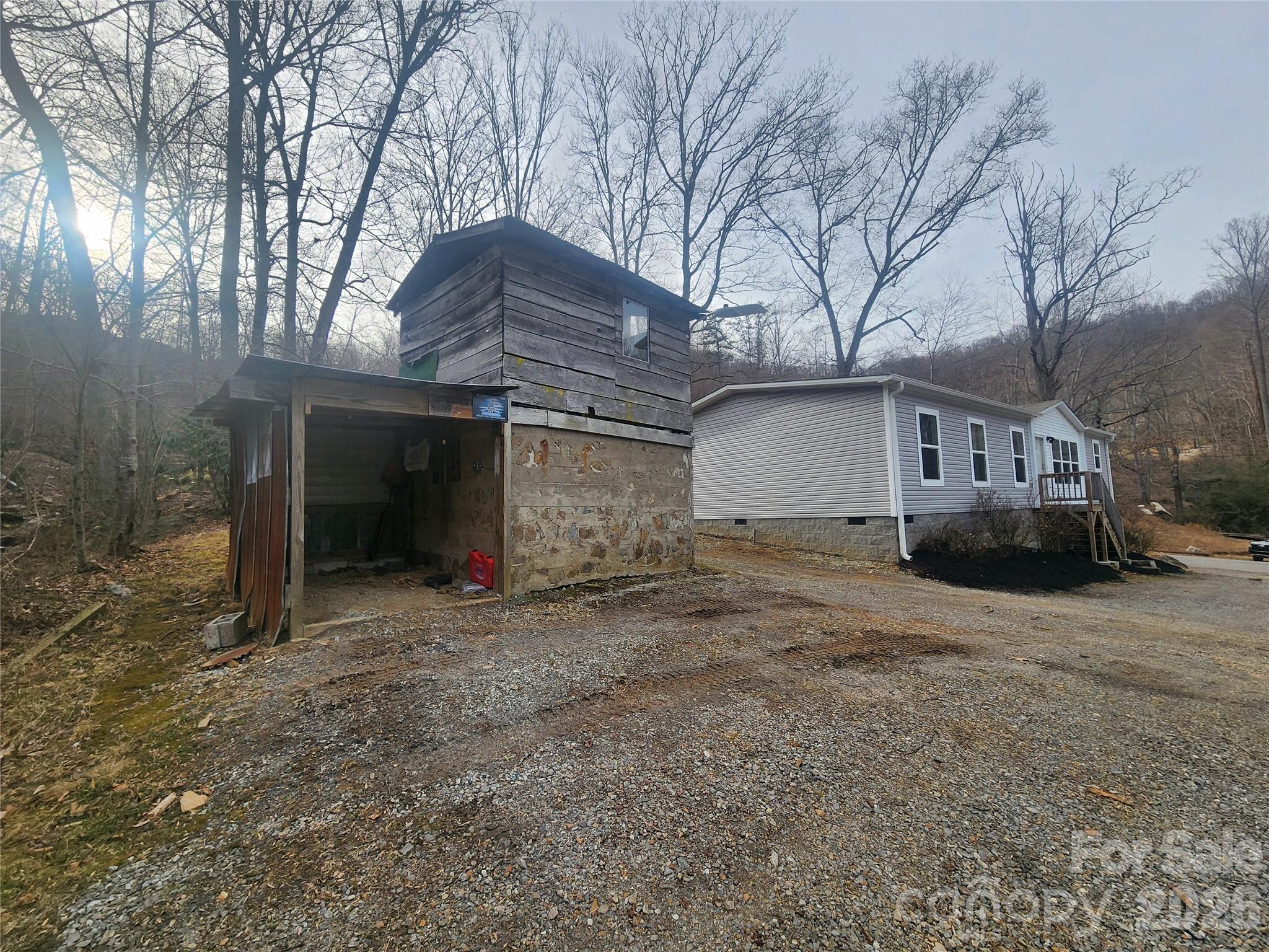 659 Cold Creek Road Canton, NC 28716 - Photo 11 of 37 a view of a house with a yard and garage