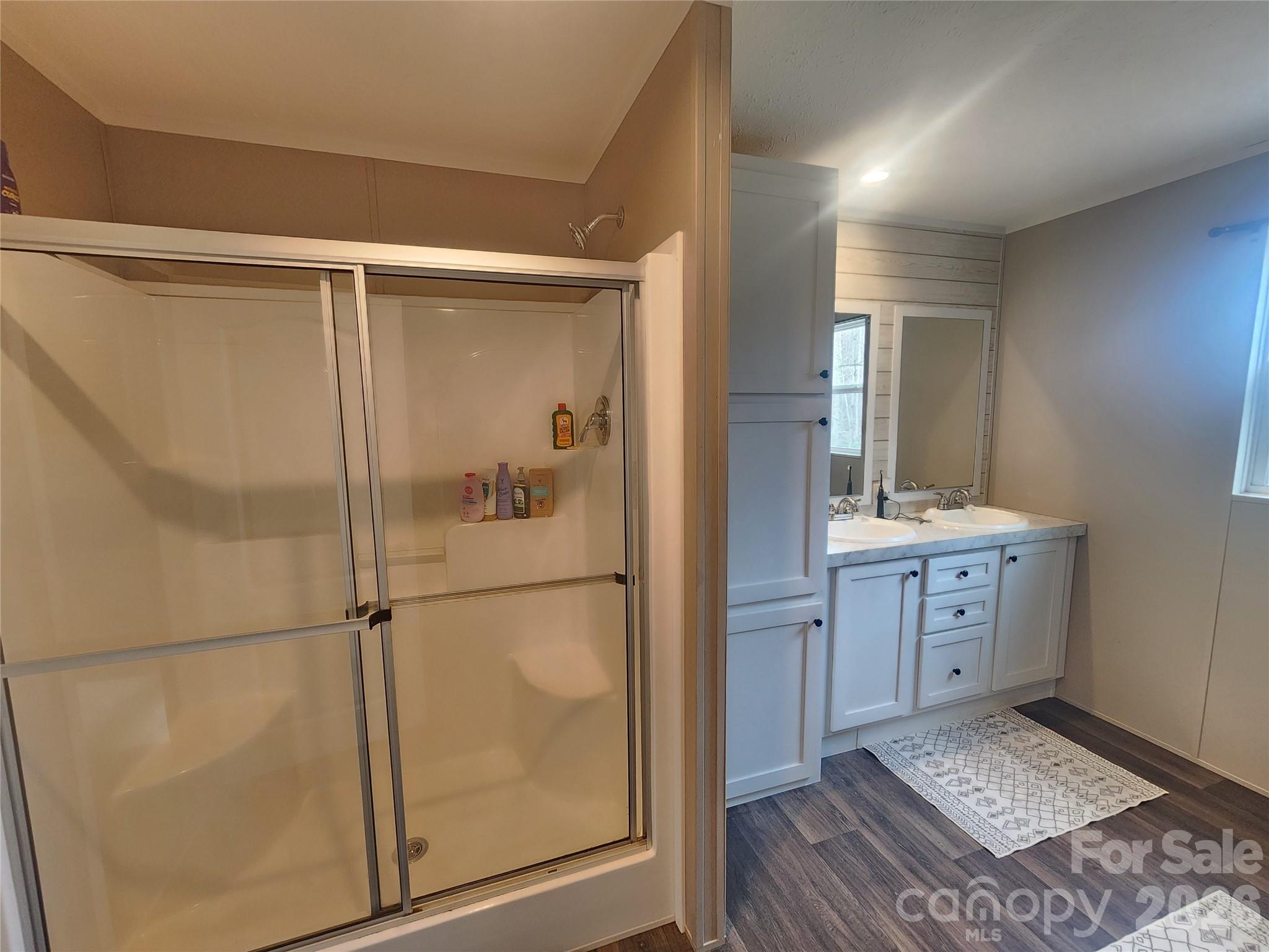 659 Cold Creek Road Canton, NC 28716 - Photo 14 of 37 a bathroom with a shower sink and mirror