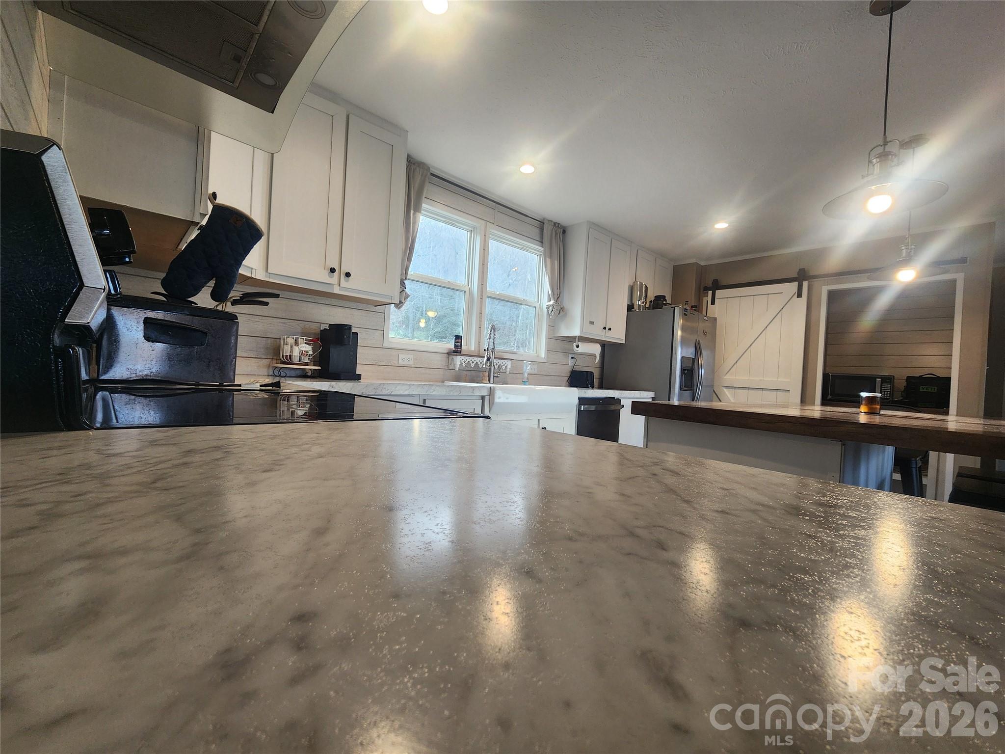 659 Cold Creek Road Canton, NC 28716 - Photo 20 of 37 a view of a kitchen with kitchen island a counter top space a sink a refrigerator and a stove