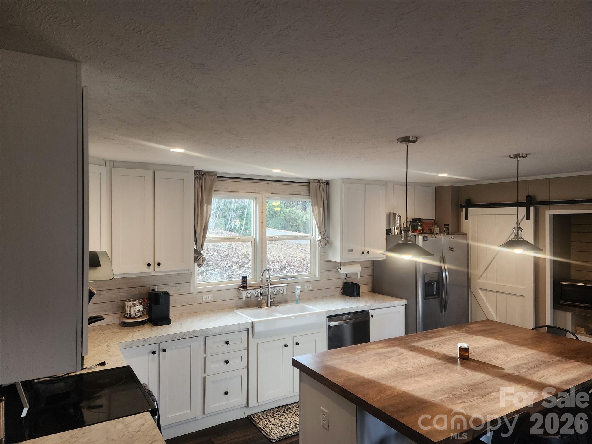 659 Cold Creek Road Canton, NC 28716 - Photo 29 of 37 a kitchen with refrigerator and cabinets