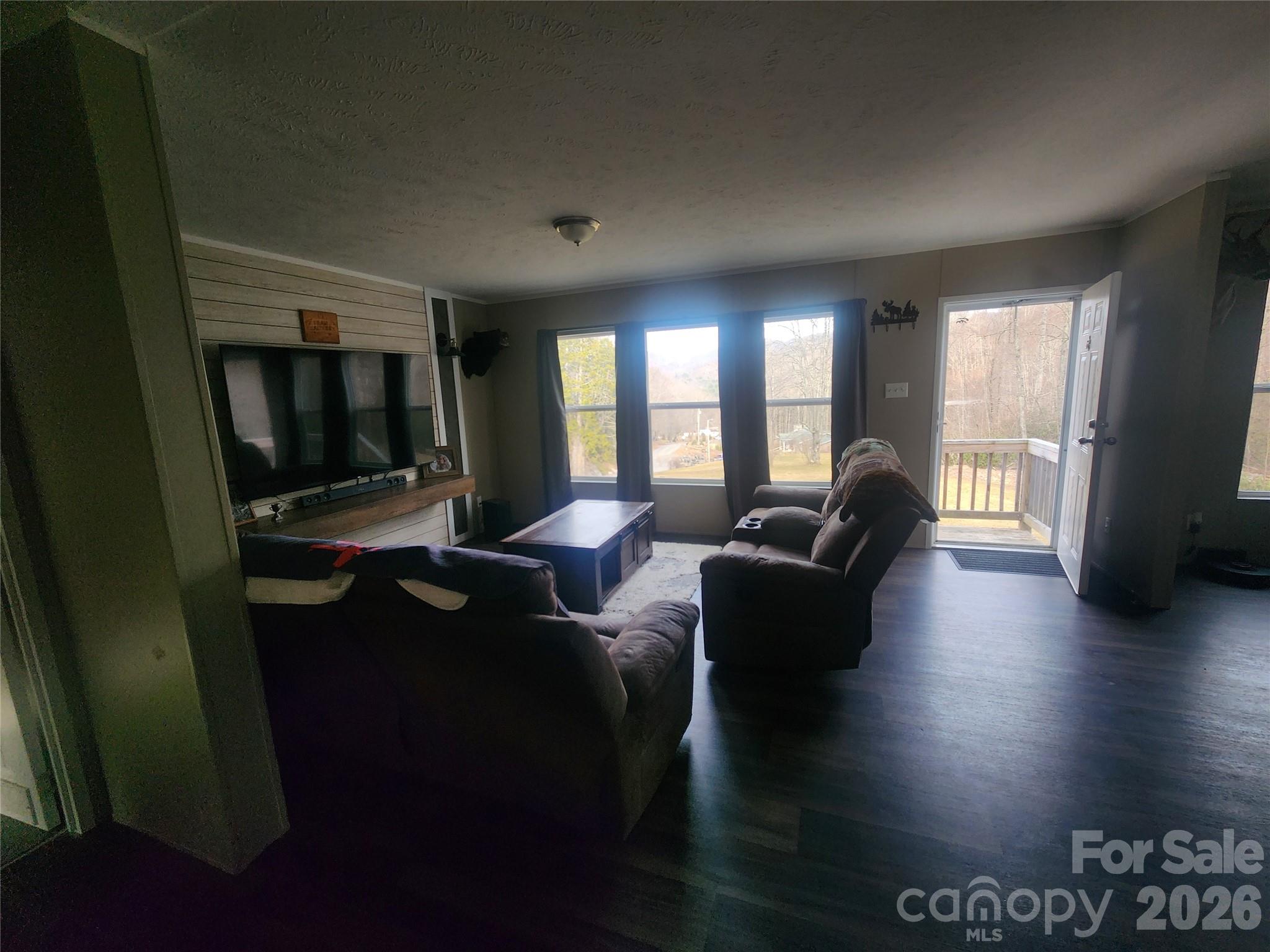 659 Cold Creek Road Canton, NC 28716 - Photo 31 of 37 a living room with furniture and a flat screen tv