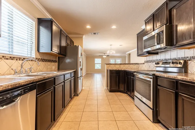 a kitchen with stainless steel appliances granite countertop a stove and a microwave
