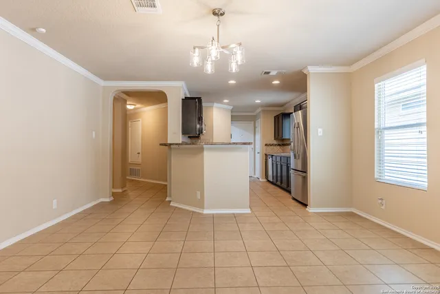 a view of an empty room with a ceiling fan