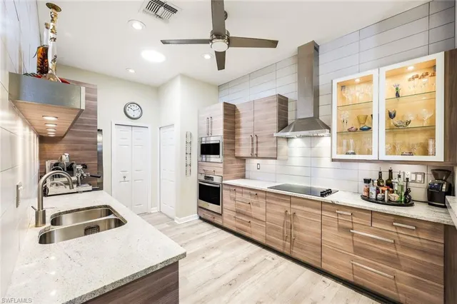 a kitchen with stainless steel appliances granite countertop a sink stove and refrigerator