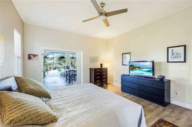 a bedroom with a bed dresser and a flat tv screen