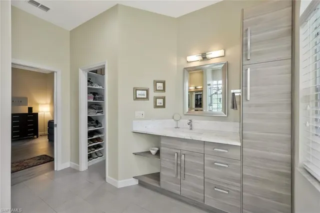 a bathroom with a shower sink and mirror
