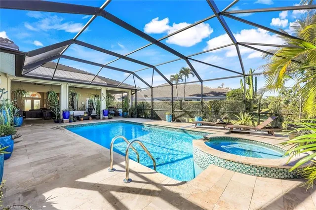 a view of a swimming pool with a patio and a yard