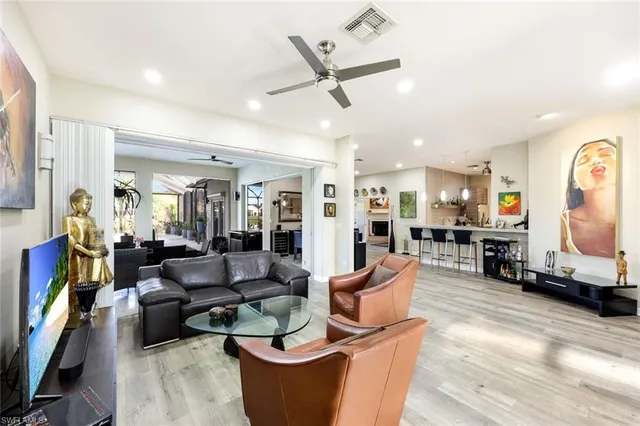 a living room with fireplace furniture and a flat screen tv