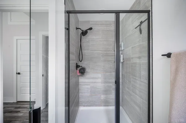a bathroom with a glass shower door