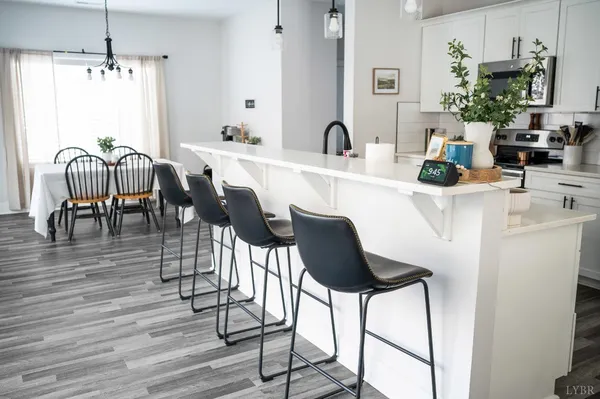 a view of a dining room with furniture and wooden floor